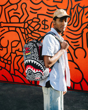 SPRAYGROUND 910B6914NSZ-KEITH HARING SKATER SHARK DLXSR BACKPACK Designers Closet